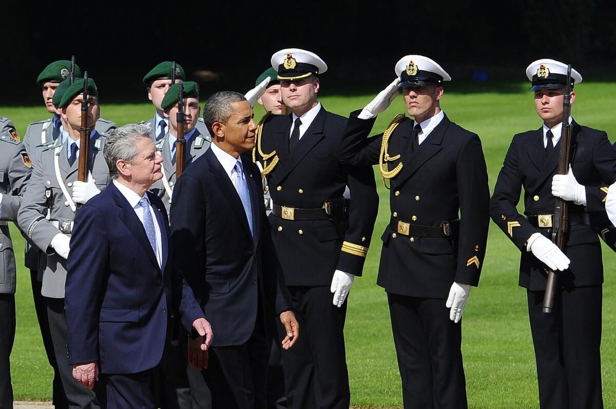 President Obama walks with German President Joachim Gauck at the Schloss Bellevue in Berlin.
