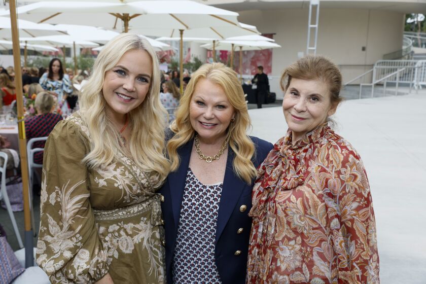 Kristen James, major event sponsor Jacquie Casey and Lee Healy of South Coast Plaza attend the Harvesters 30th annual Fashion Show and Luncheon.