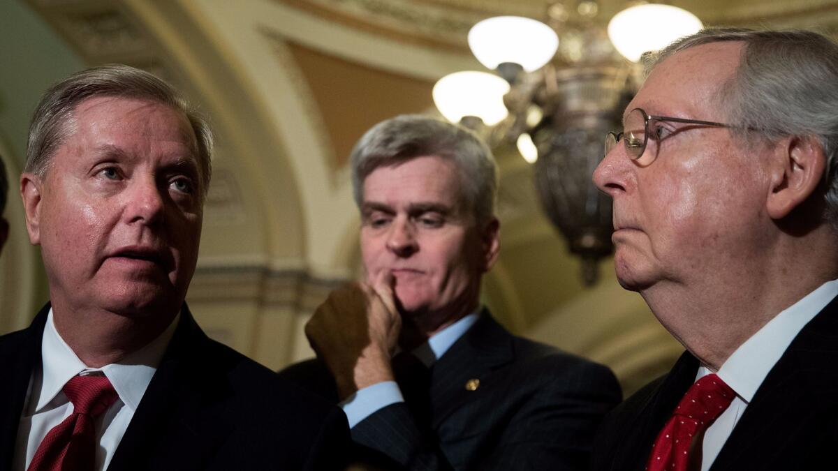 Sens. Lindsey Graham and Bill Cassidy, authors of the most recent Republican attempt to repeal Obamacare, speak at a news conference in Washington alongside Senate Majority Leader Mitch McConnell on Sept. 26.