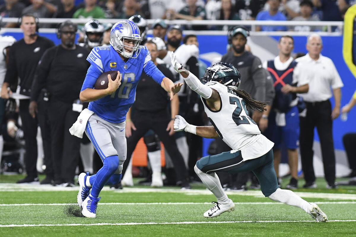 Detroit Lions quarterback Jared Goff (16) runs the ball as Philadelphia Eagles cornerback Avonte Maddox (29) defends in the second half of an NFL football game in Detroit, Sunday, Sept. 11, 2022. (AP Photo/Lon Horwedel)