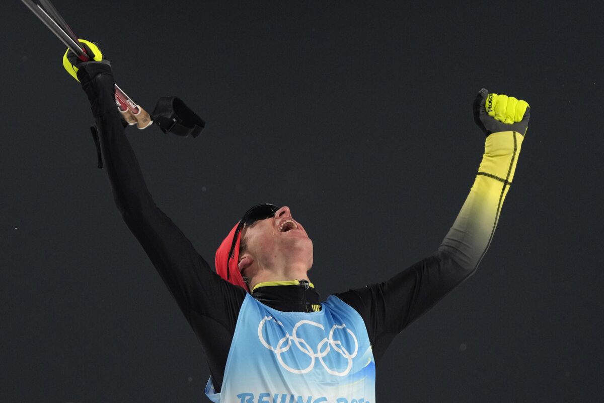 Gold medal finisher Germany's Vinzenz Geiger celebrates after the cross-country skiing portion of the individual Gundersen normal hill/10km event at the 2022 Winter Olympics, Wednesday, Feb. 9, 2022, in Zhangjiakou, China. (AP Photo/Alessandra Tarantino)