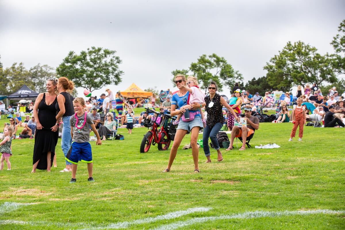 Attendees dancing to the music during a 2022 "Concerts on the Green" show in Pacific Beach.
