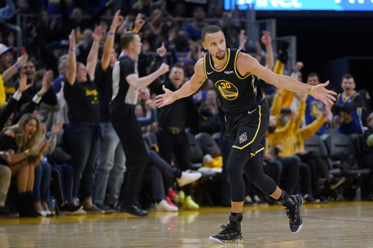 Golden State Warriors guard Stephen Curry (30) celebrates after hitting a 3-point basket against the Denver Nuggets during the first half of Game 1 of an NBA basketball first-round playoff series in San Francisco, Saturday, April 16, 2022. (AP Photo/Jeff Chiu)