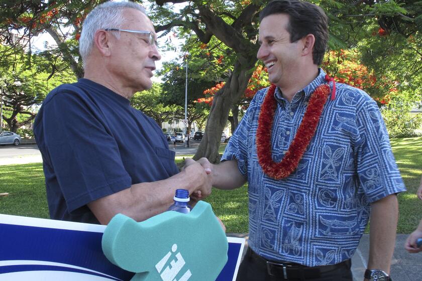 U.S. Sen. Brian Schatz, right, greets a supporter during a campaign event in Honolulu. Schatz faces a primary challenge from Rep. Colleen Hanabusa.