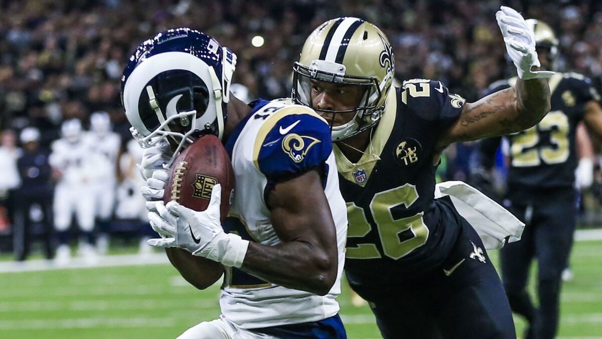 Rams wide receiver Brandin Cooks (L) catches a pass as New Orleans Saints cornerback P.J. Williams (R) defends during the first half of the NFC championship game in the Mercedes-Benz Superdome.