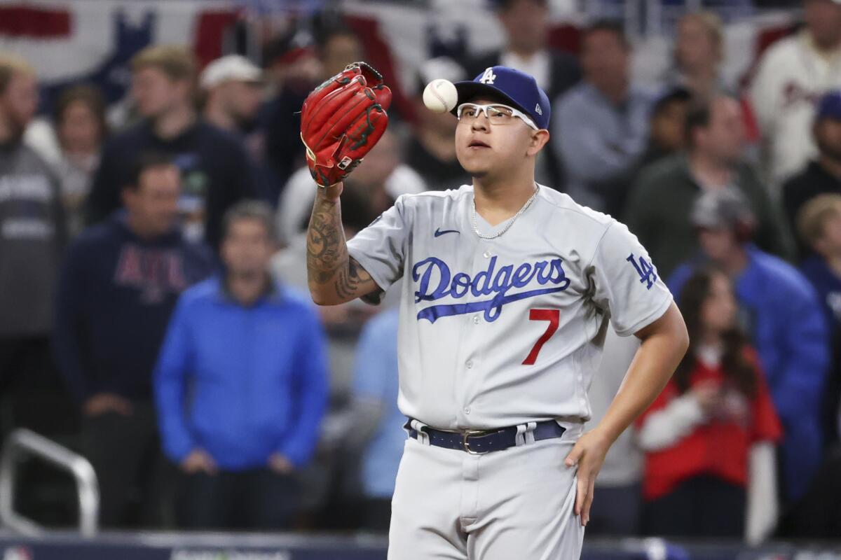 Dodgers starting pitcher Julio Urias tosses a baseball on the mound during the eighth inning.