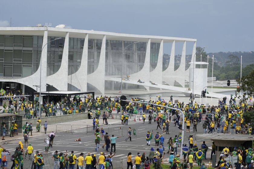 Brasilia's Planalto Palace, its roof supported by spear-shaped arches, is invaded by insurrectionists on Jan. 8, 2022