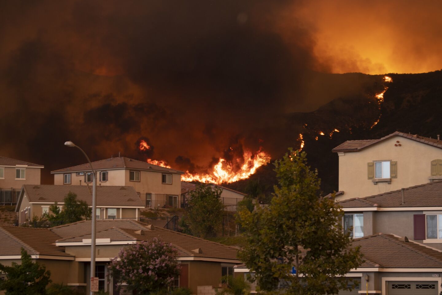 The Holy fire on Wednesday approaches Lake Elsinore's McVicker Canyon neighborhood, which is under mandatory evacuation orders.