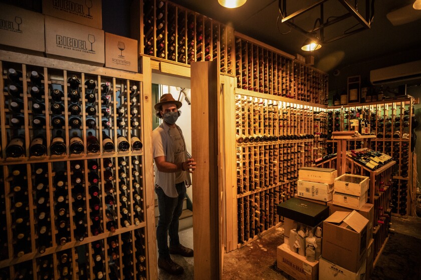 A man stands at the entrance to a wine cellar