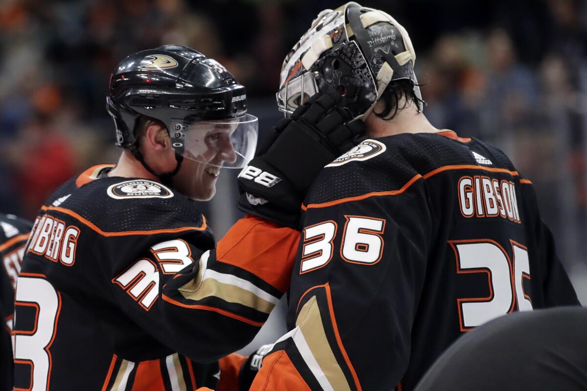 The Ducks' Jakob Silfverberg, who scored in regulation and in the shootout, celebrates with goalie John Gibson on Dec. 14, 2019.