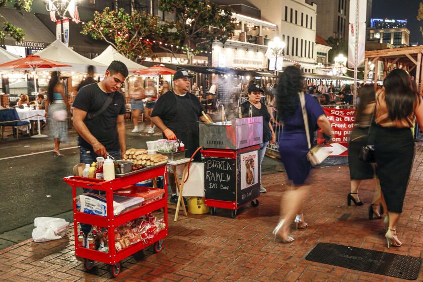 Street vendors sell food items along 5th avenue and Market Street in the Gaslamp Quarter on Saturday, August 27, 2021.(Photo by Sandy Huffaker)