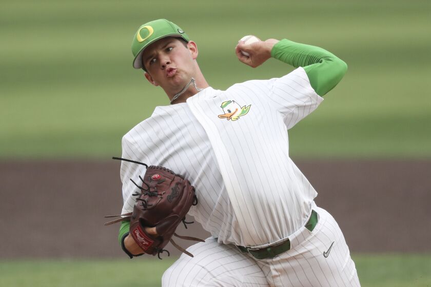 Oregon pitcher Grayson Grinsell pitches against Oral Roberts during the second inning of an NCAA college baseball tournament super regional game Friday, June 9, 2023, in Eugene, Ore. (AP Photo/Amanda Loman)