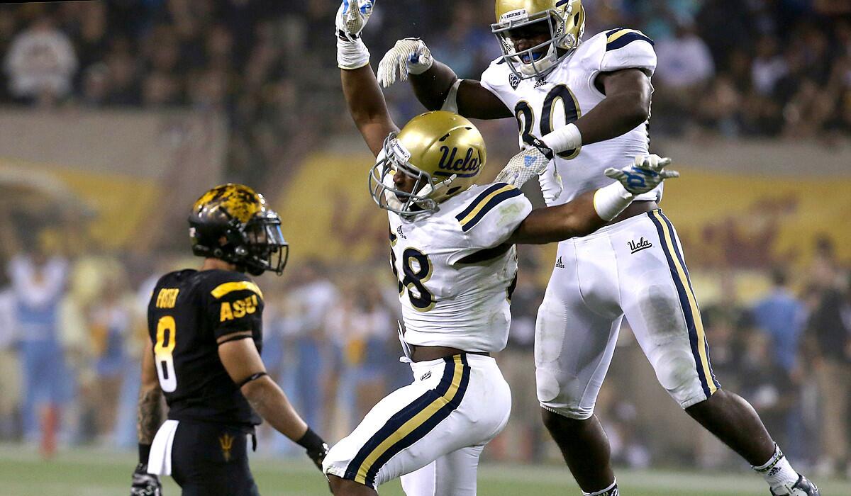 UCLA linebackers Deon Hollins and Myles Jack celebrate after recovering a fumble by Arizona State quarterback Mike Bercovici in the third quarter of their Sept. 25 game in Tempe, Ariz.