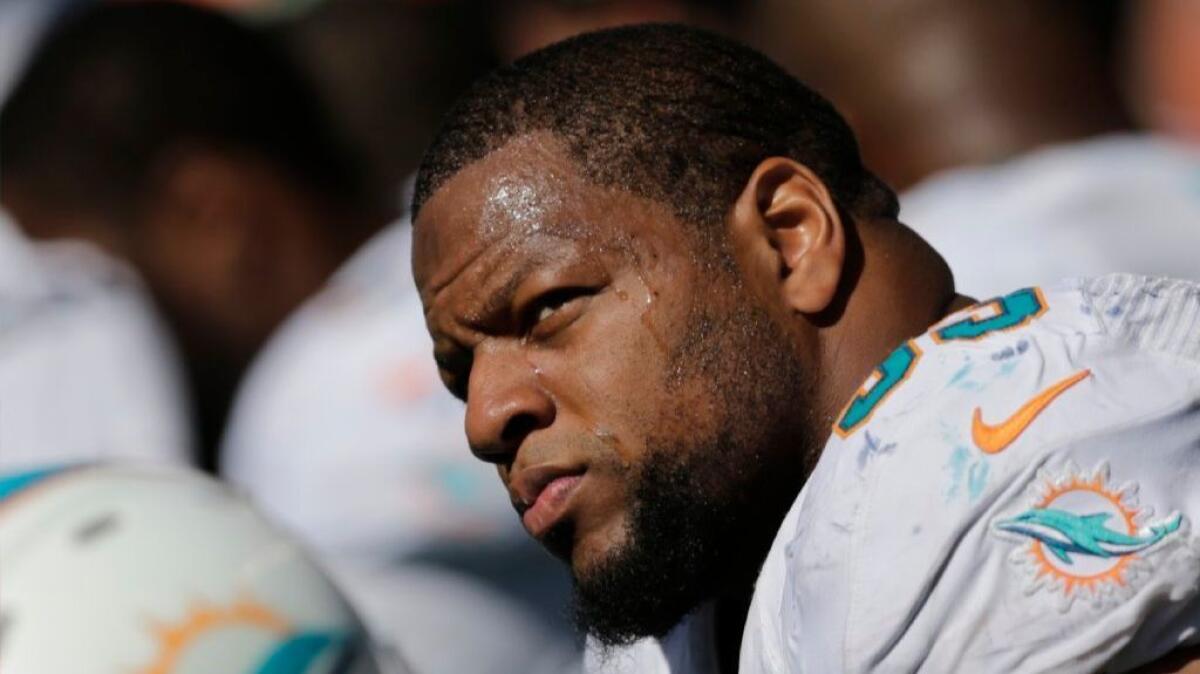 Dolphins defensive tackle Ndamukong Suh sits on the sideline during the first half of a game against the Seahawks on Sept. 11.