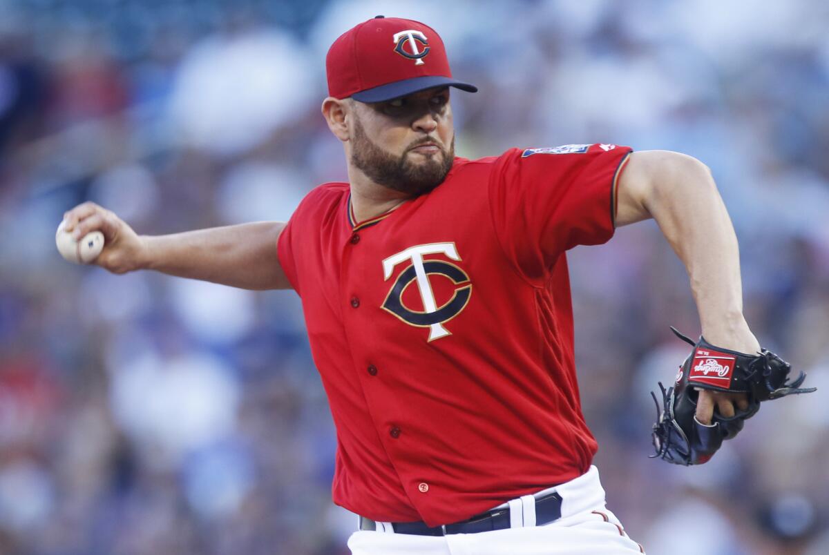 Ricky Nolasco, above, moves from Minnesota to the Angels, who sent Hector Santiago to the Twins in a four-pitcher trade.
