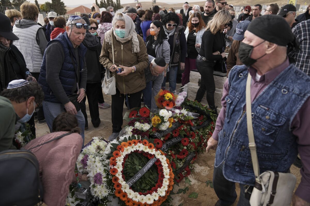 Family and friends of Roman Brodsky gather at his grave during his funeral in Arad, southern Israel. 
