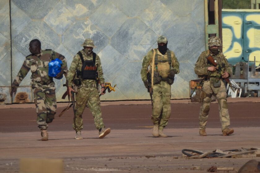 This undated photograph handed out by French military shows three Russian mercenaries, right, in northern Mali. Western officials say violence against civilians in Mali has risen in the year since hundreds of Russian mercenaries have started working alongside the West African country's armed forces to stem a decade-long insurgency by Islamic extremists. Diplomats, analysts and human rights groups say extremists linked to al-Qaida and the Islamic State group have only gotten stronger and there's concern the Russian presence will further destabilize the already-troubled region.(French Army via AP)