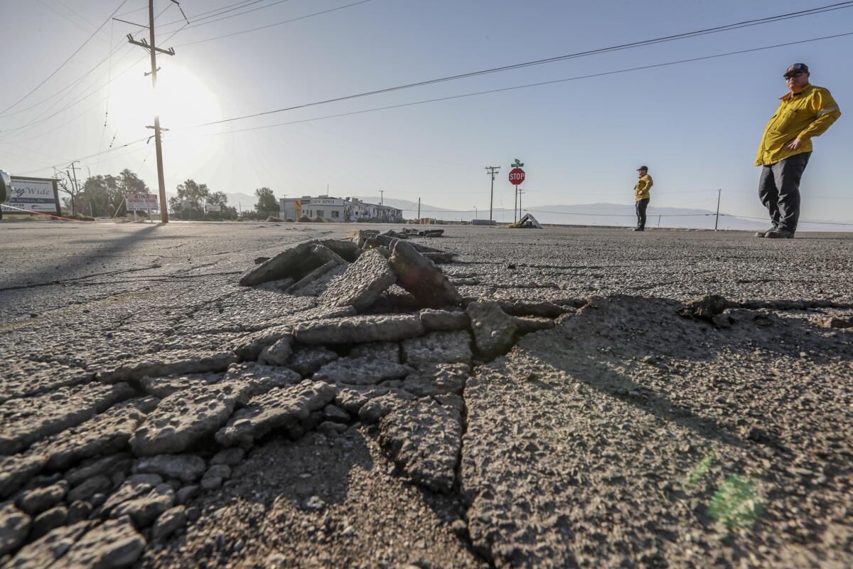 Buckled asphalt, in a parking lot near Trona Road in Argus, Calif., is evidence of recent quakes.