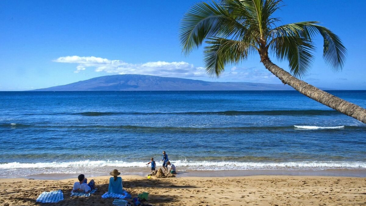 Beachgoers enjoy the sand and waters of Kaanapali Beach on Maui in Hawaii. Maui will be one of two destinations for Southwest Airlines' new nonstop flights between San Diego and Hawaii, debuting in April.