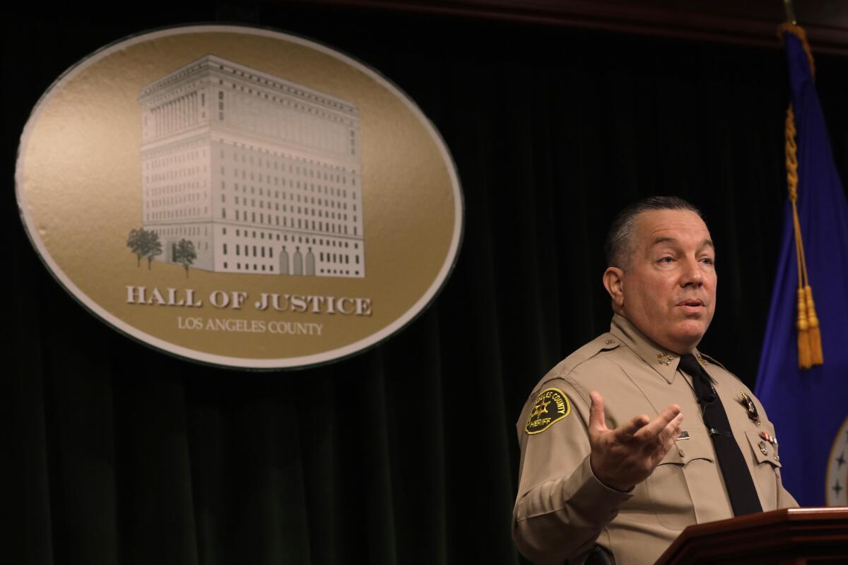 Sheriff Alex Villanueva speaks at a lectern at the Hall of Justice in downtown Los Angeles.