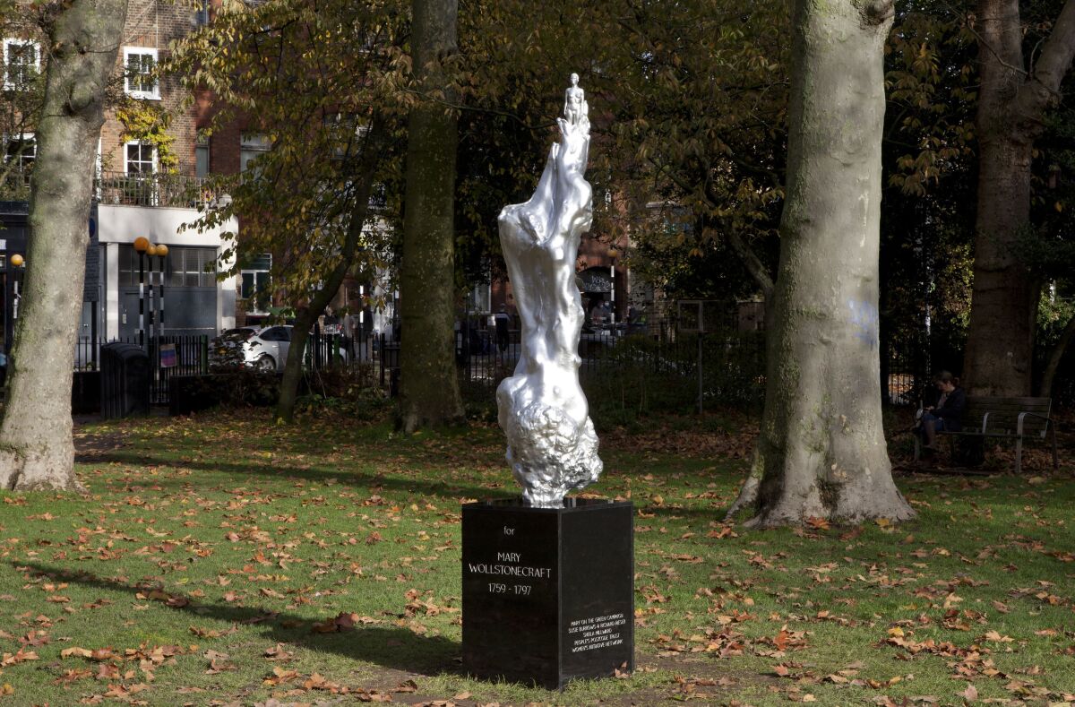 This undated handout photo issued by the Mary on the Green campaign of Maggi Hambling's 'A Sculpture for Mary Wollstonecraft' which has been unveiled on Newington Green, London. A sculpture celebrating Mary Wollstonecraft as the mother of feminism has attracted criticism even before it was unveiled. Artist Maggi Hambling said the sculpture “celebrates the spirit of Mary Wollstonecraft,” the author of the 18th-century treatise “A Vindication of the Rights of Woman.” The sculpture was unveiled Tuesday, Nov, 10, 2020 after a decade of campaigning and fundraising, but many critics took to Twitter to question why it had to feature a naked female figure. (Ioana Marinescu/Mary on the Green via AP)