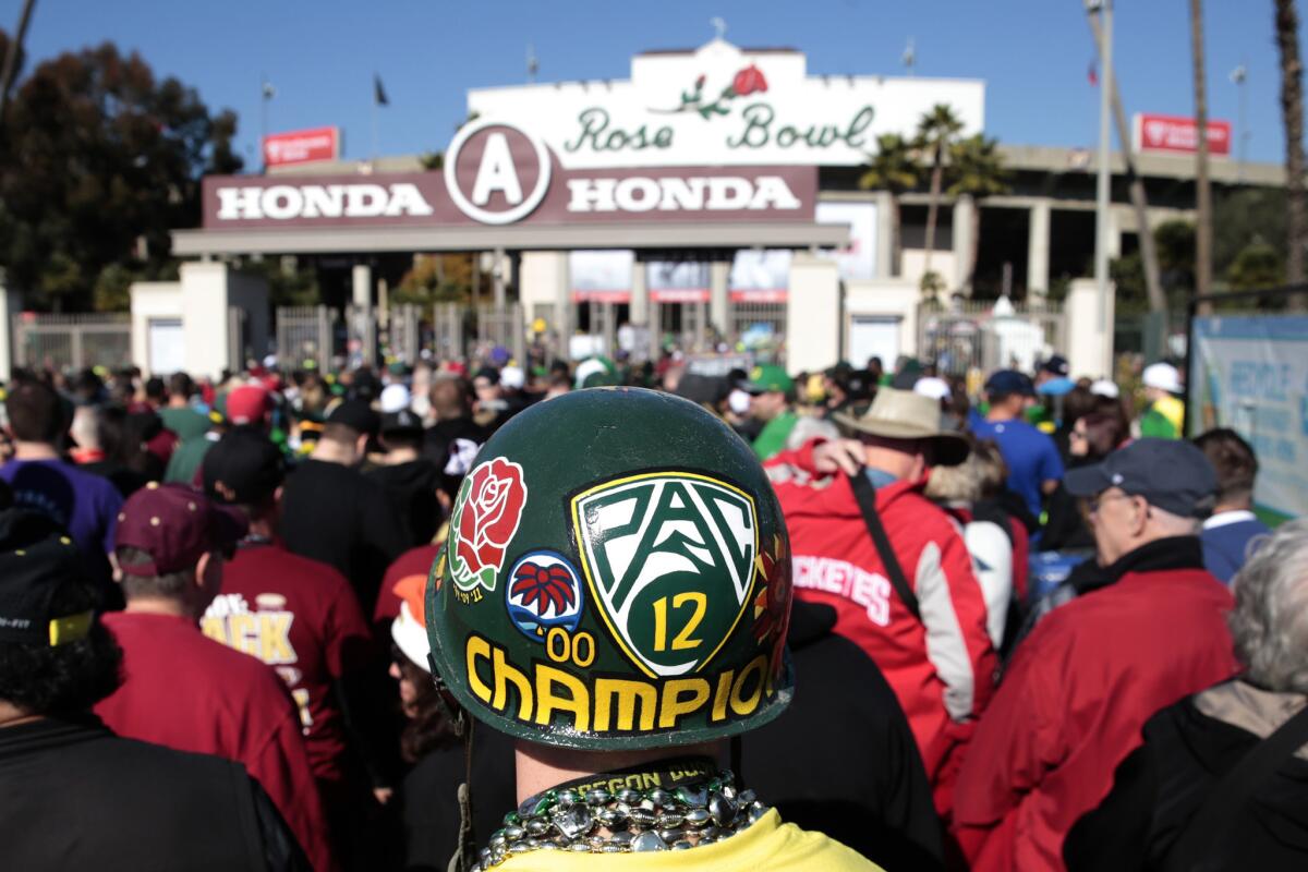 Fans arrive at the Rose Bowl for the College Football Playoff semifinal game between Pac-12 champion Oregon and ACC champion Florida State.