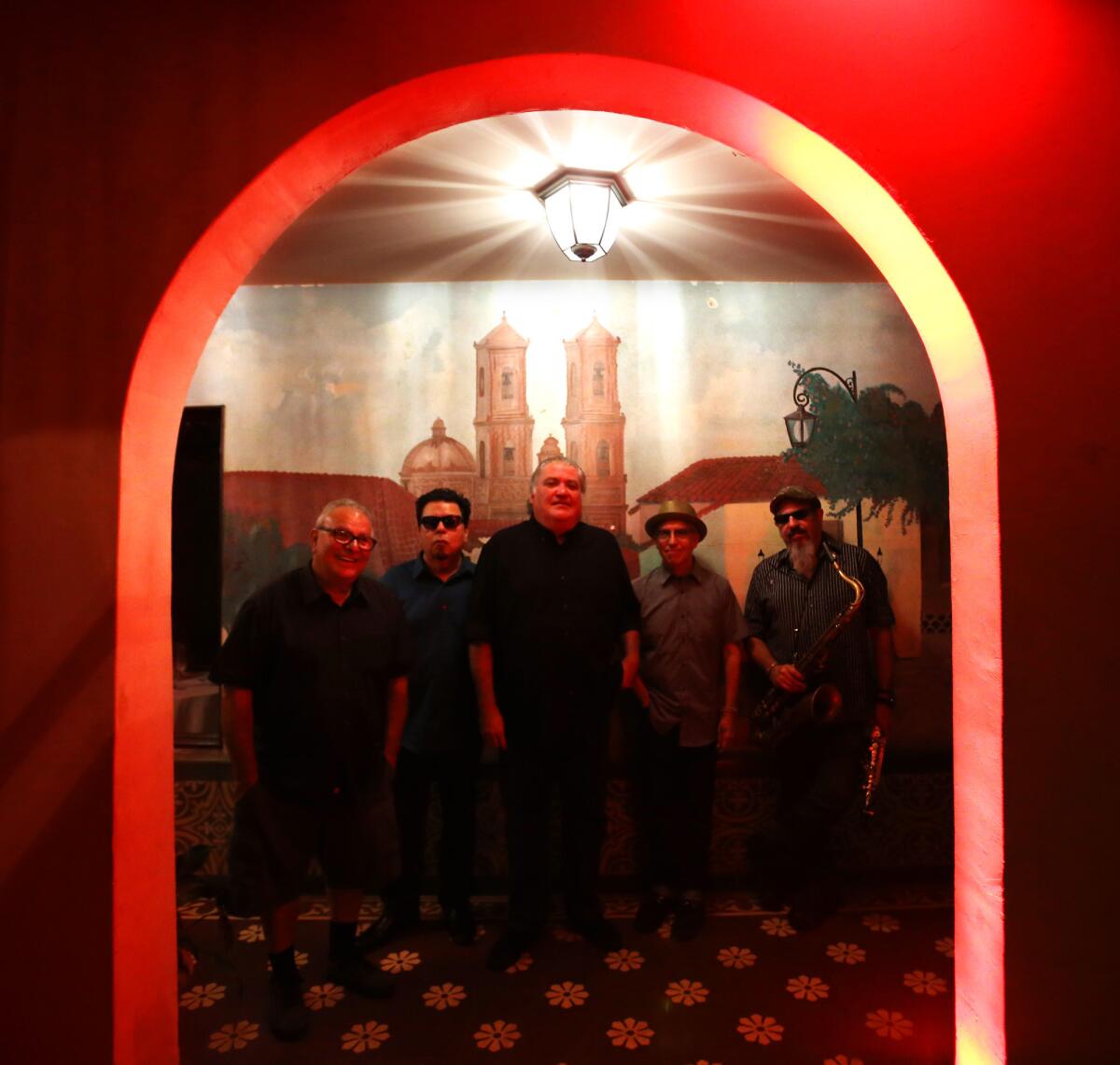 EAST LOS ANGELES, CA - SEPTEMBER 29, 2015 -- Los Lobos members Conrad Lozano, from left, Cesar Rosas, David Hidalgo, Louie Perez and Steve Berlin pose for a portrait before performing an intimate concert for family and friends to celebrate their new album, "Gates of Gold," at El Gallo Plaza in East Los Angeles on September 29, 2015. (Genaro Molina/ Los Angeles Times)