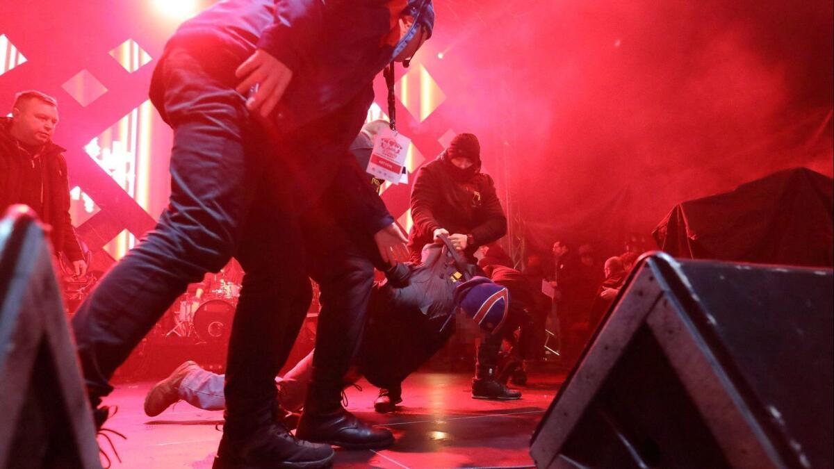 Security staff trying to stop a man after he attacked Mayor of Gdansk Pawel Adamowicz during the 27th finale of the Great Orchestra of Christmas Charity in Gdansk, Poland.