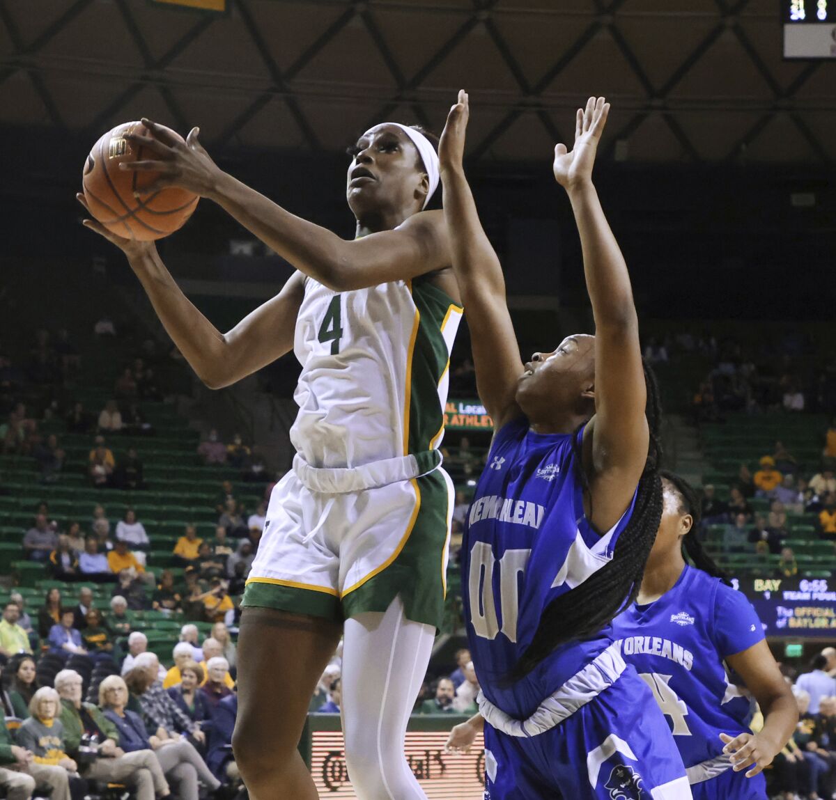 Baylor center Queen Egbo shoots in front of New Orleans guard Jomyra Mathis during the first half of an NCAA college basketball game Monday, Nov. 15, 2021, in Waco, Texas. (Rod Aydelotte/Waco Tribune-Herald via AP)
