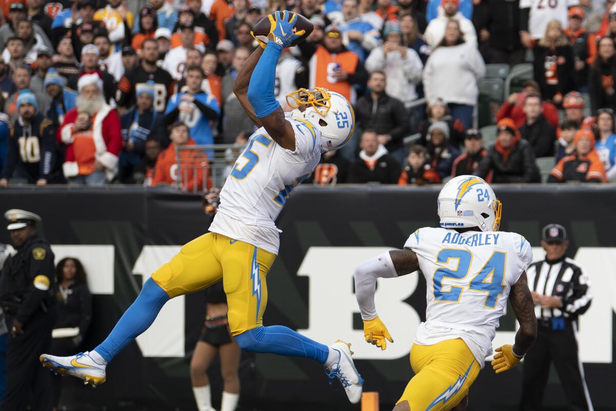 Chargers cornerback Chris Harris Jr. intercepts a Joe Burrow pass in the second half against the Bengals.