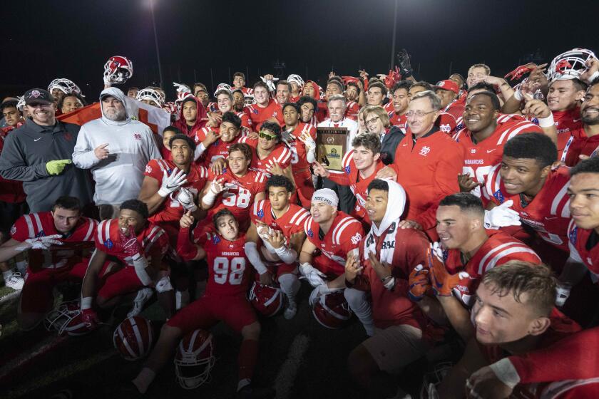 Long Beach, CA - November 26: Mater Dei players pose for photos after defeating Servite.