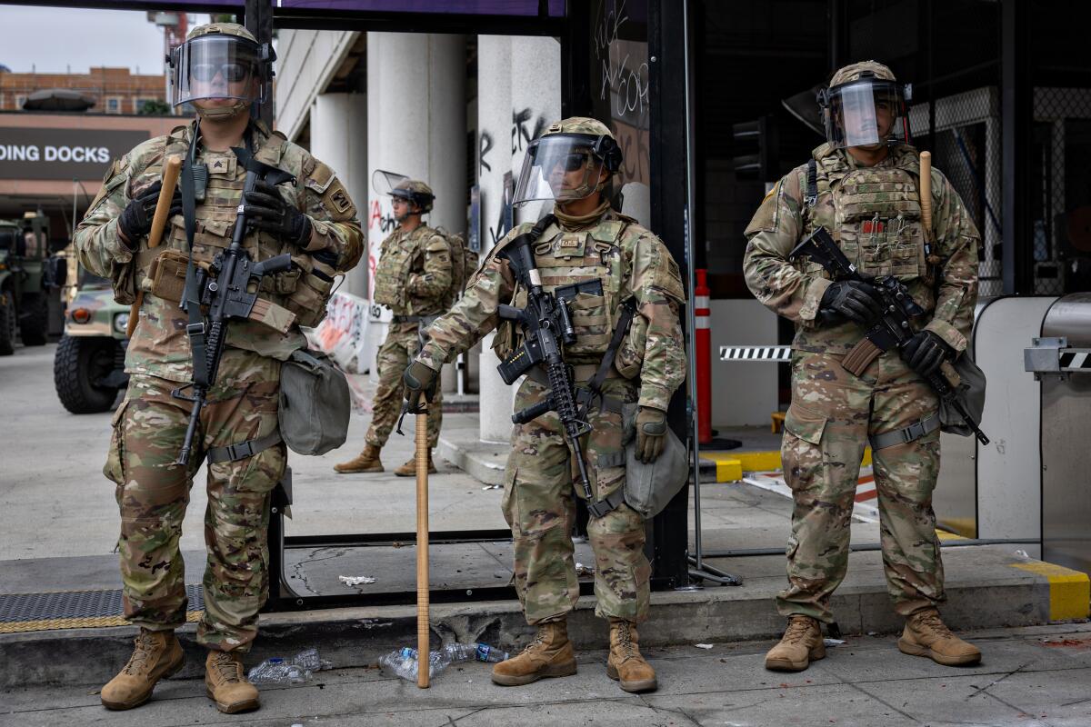 National guard standing in front of loading docks.