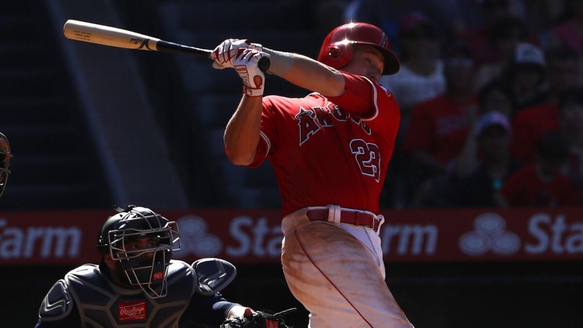 Matt Thaiss hits a three-run home run during the eighth inning of the Angels' 6-3 victory over the Seattle Mariners on Sunday.