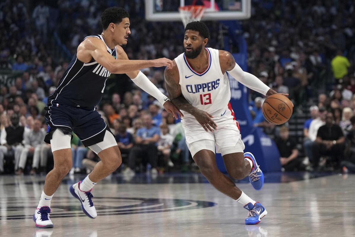 Clippers forward Paul George, right, drives against Mavericks guard Josh Green during Game 4 of their playoff series in April