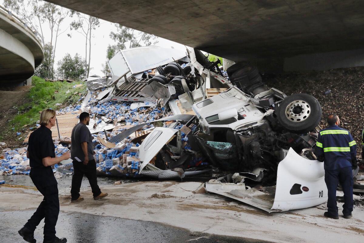 Cleanup is underway after a big-rig crash Thursday morning left hundreds of cans of Modelo Especial beer scattered across and under a 10 Freeway overpass.