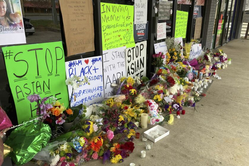 A make-shift memorial is seen Friday, March 19, 2021, in Acworth, Ga., in the aftermath of shootings. Eight people killed Tuesday in shootings at three metro Atlanta massage businesses. Police have charged a 21-year-old Robert Aaron Long with the slayings. (AP Photo/Candice Choi)