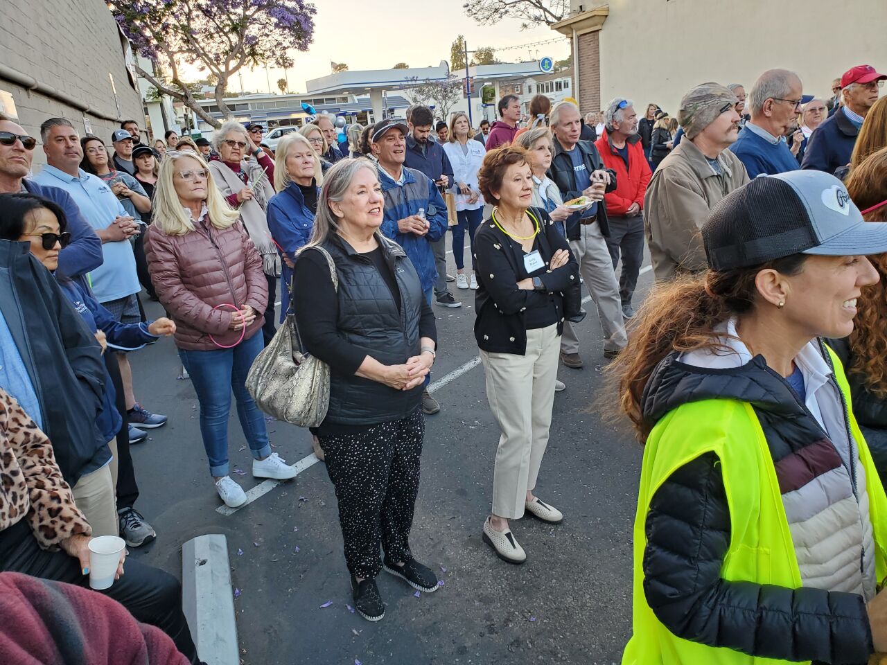 A crowd of Point Loma residents attends the celebratory lighting of Rosecrans Street with the overhead Village Lights.