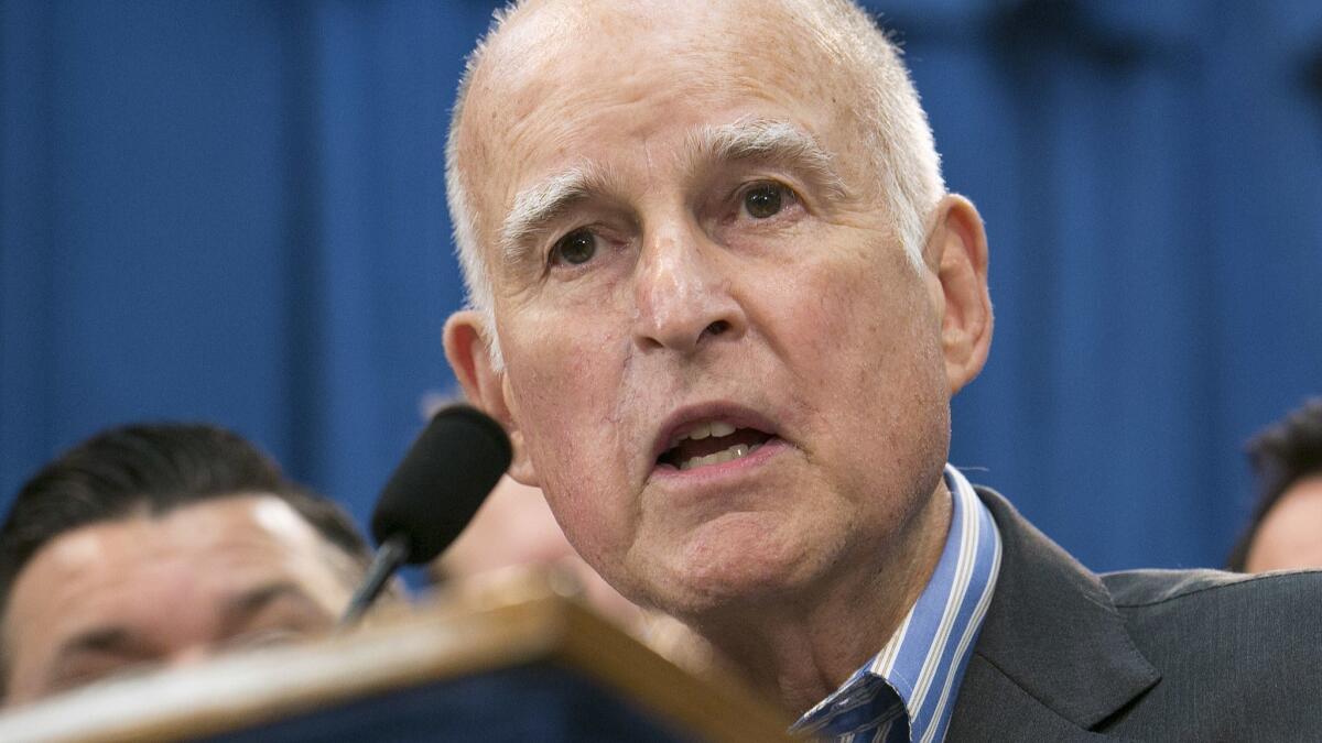 Gov. Jerry Brown speaks at a Capitol news conference in July after signing “sanctuary state” legislation that extends protections for immigrants living in the United States without documents.