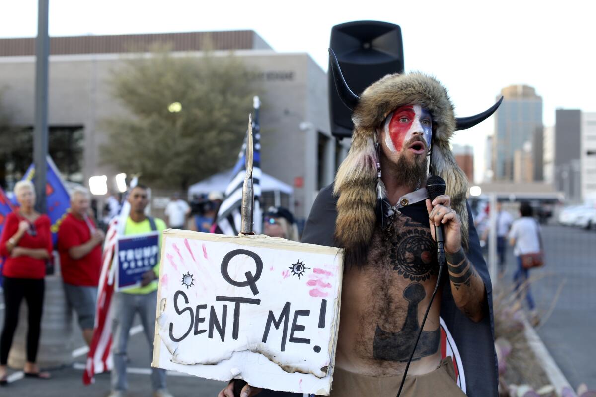 Jacob Anthony Chansley speaks to supporters of then-President Trump in Phoenix as votes were being counted four years ago.