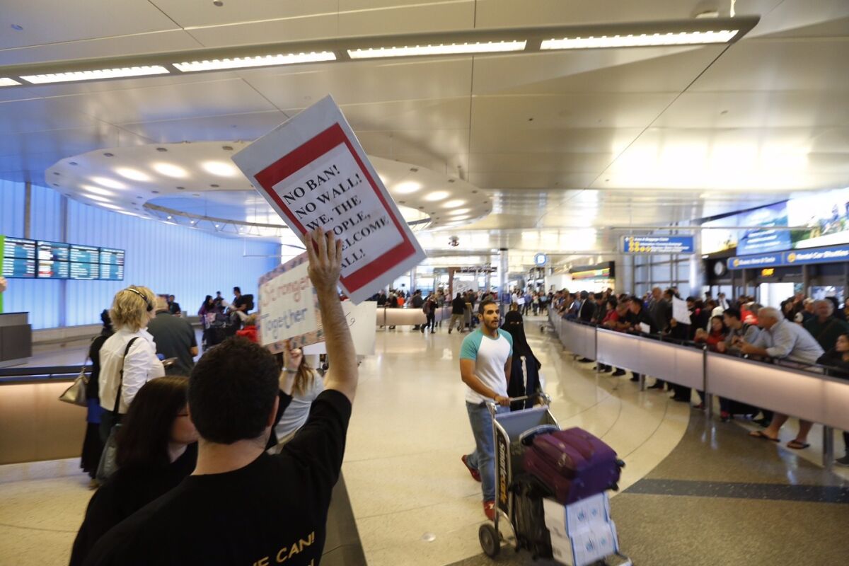 A crowd protests President Trump's travel ban at the Tom Bradley Terminal at LAX on Sunday.