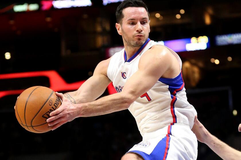 Clippers guard J.J. Redick pulls down a rebound against the Knicks on Wednesday night at Staples Center.