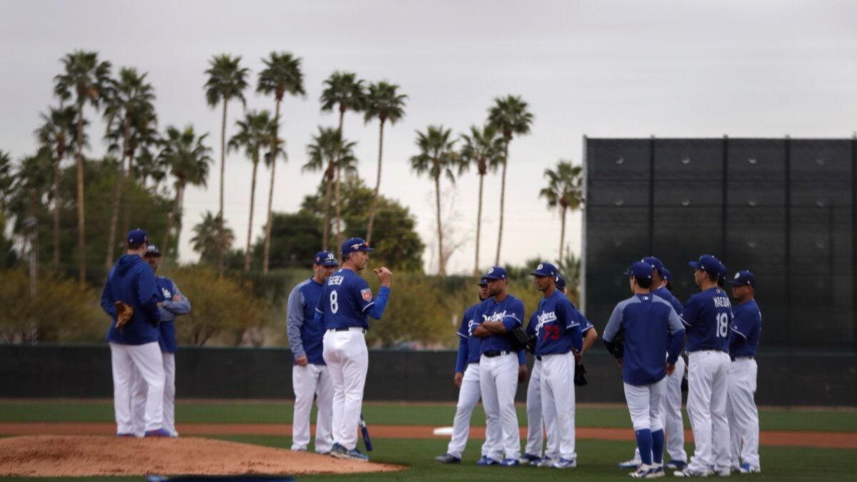 Dodgers bench coach Bob Geren (8) talks with pitchers at the team's spring-training facility in Arizona.