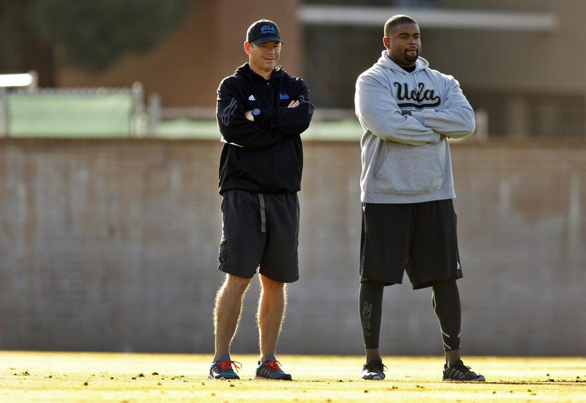 UCLA offensive line coach Adrian Klemm, right, was reinstated by the university Friday following a suspension for alleged NCAA violations.