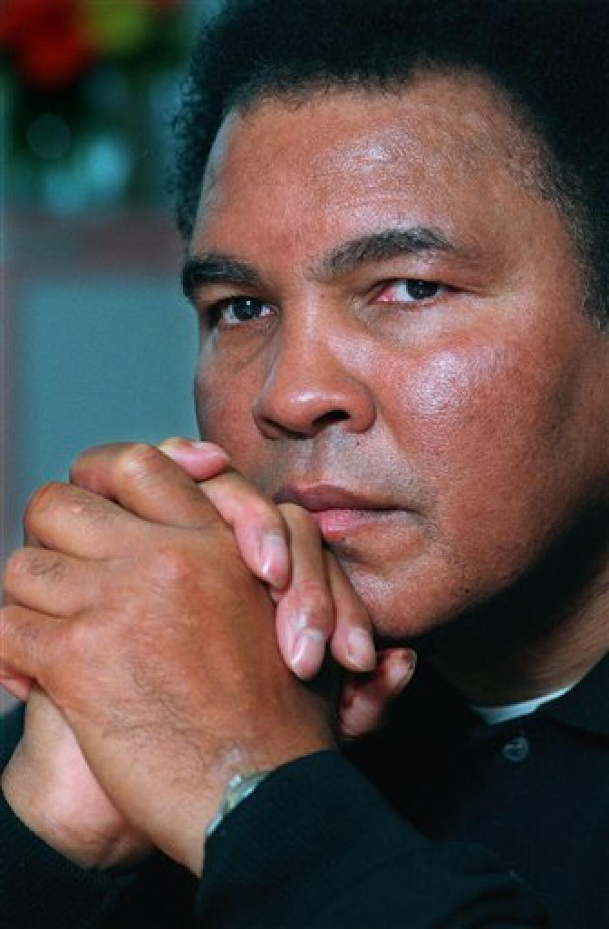 FILE - In this Feb. 2, 1999 file photo, boxing legend Muhammad Ali poses for a photo after an interview in New York. The man who became the world's most recognizable athlete was a baby sitter, a jokester and a dreamer in the predominantly black West End neighborhood of Louisville where he grew up and forged lasting friendships while beginning his ascent toward greatness. Now, as the iconic boxer slowed by Parkinson's disease prepares to turn 70 next week, he's coming home for a birthday bash at the downtown cultural center and museum that bears his name. (AP Photo/Richard Drew, File)