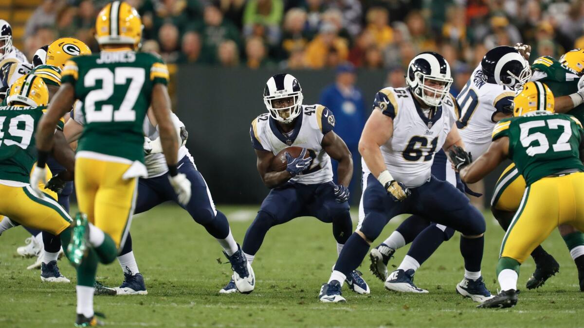 Former USC running back Justin Davis runs for the Rams during a game against Green Bay on Aug. 31.