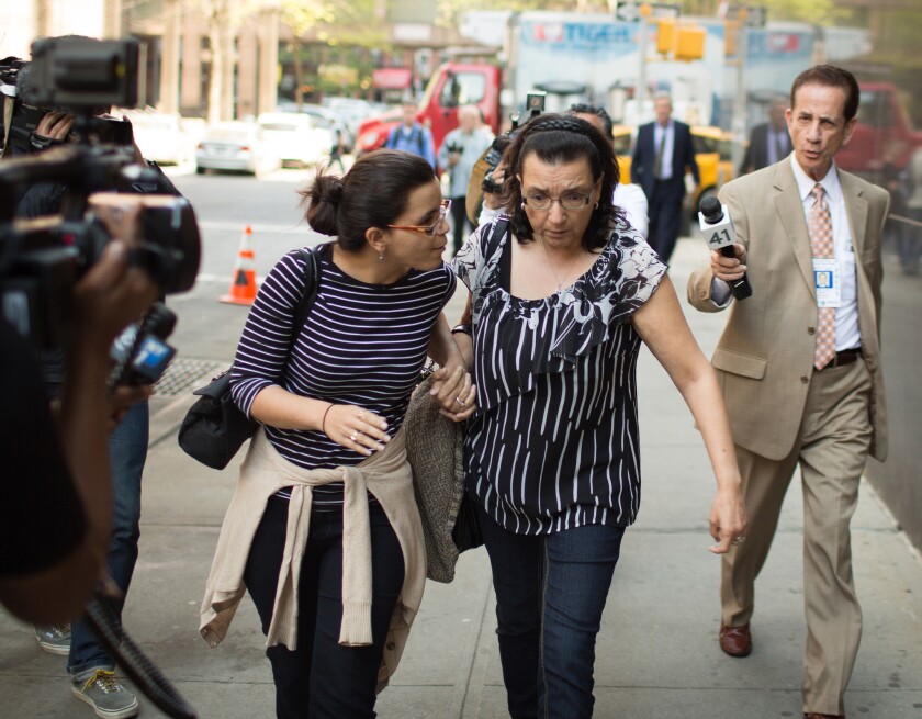 Pedro Hernandez’s daughter, Becky Hernandez (left), holds hands with her mother, Rosemary Hernandez, as they exit court on May 8.