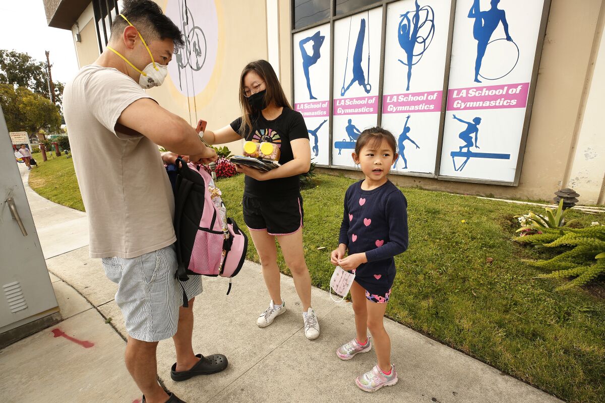 Shawn Chou and Jennifer Lee drop off their daughter Samantha Chou, 6, at LA Gymnastics in Culver City