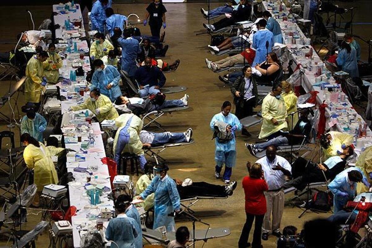 Dozens of volunteer dentists work on participants in the Remote Area Medical expedition at the Forum in Inglewood on Tuesday. Services are provided by volunteer medical and dental personnel for the uninsured, underinsured, unemployed and those who cannot afford to pay.