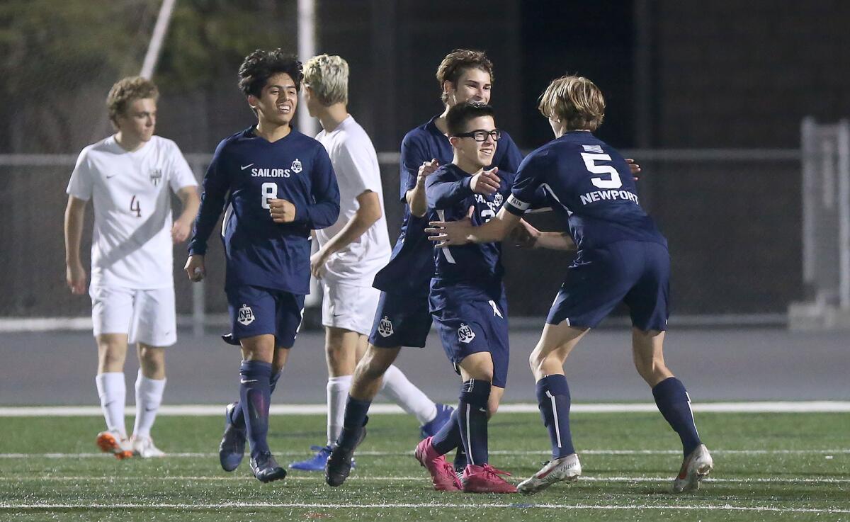 Newport Harbor's Jack Starnes (5), pictured celebrating with Anthony Vasquez (3) and Yamil Razo (8) in a Jan. 3 match against Laguna Beach, led the Sailors past Corona del Mar 2-1 on Wednesday.