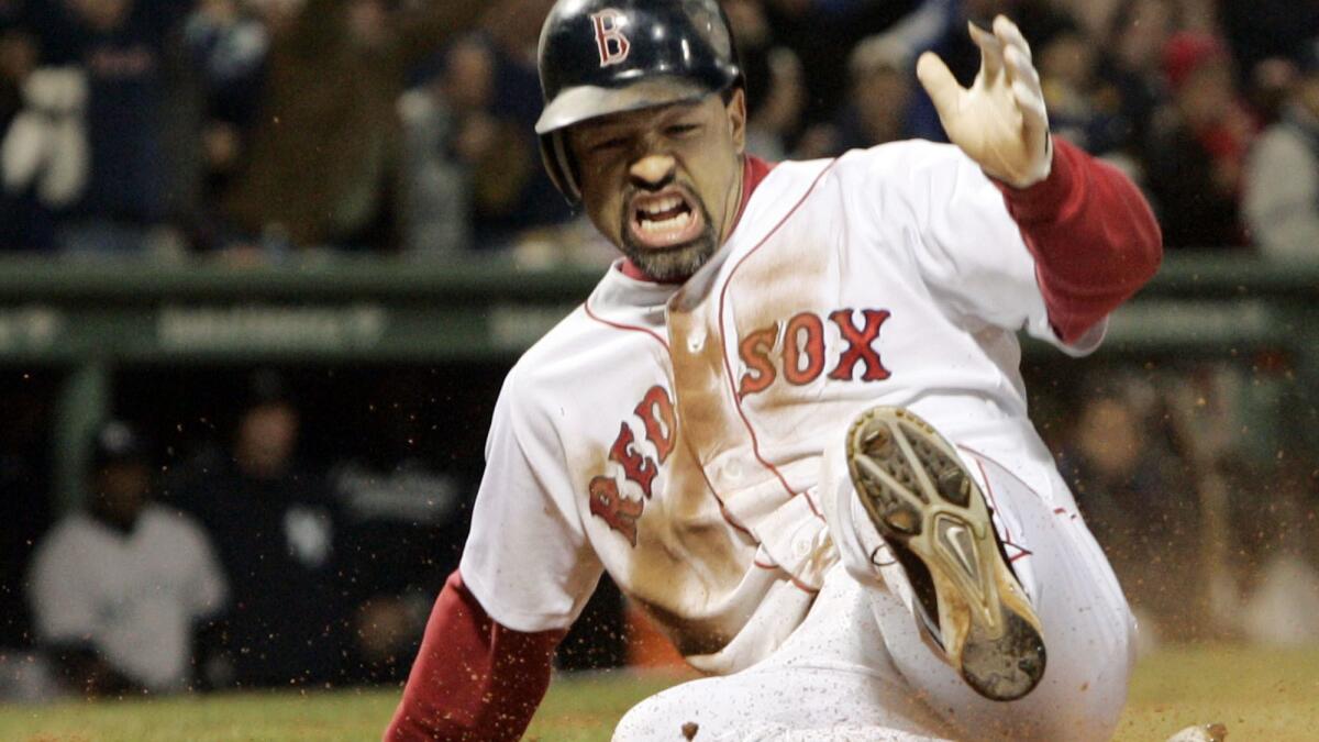 Boston Red Sox's Dave Roberts slides home to score the tying run against New York Yankees' Mariano Rivera in the ninth inning of Game 4 of the ALCS on Oct. 17, 2004 in Boston.